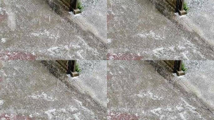 夏季雷暴时冰雹落下的地面视图。慢动作冰雹，冰雹落到阳台上，