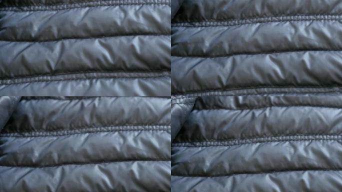 暖冬羽绒服的合成表面慢倾斜4K 2160p 30fps超高清镜头-管壁填充夹克的特写3840X216