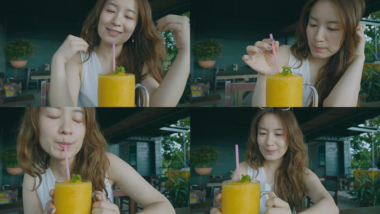 女孩喝橙汁