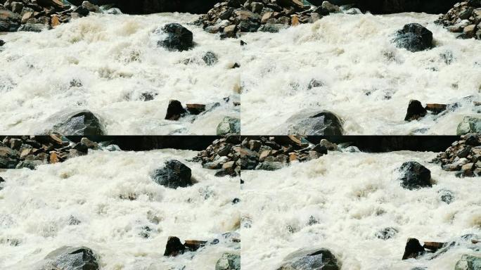 山河从冰川下流出，一股强大的水流在岩石上破碎特写，慢动作
