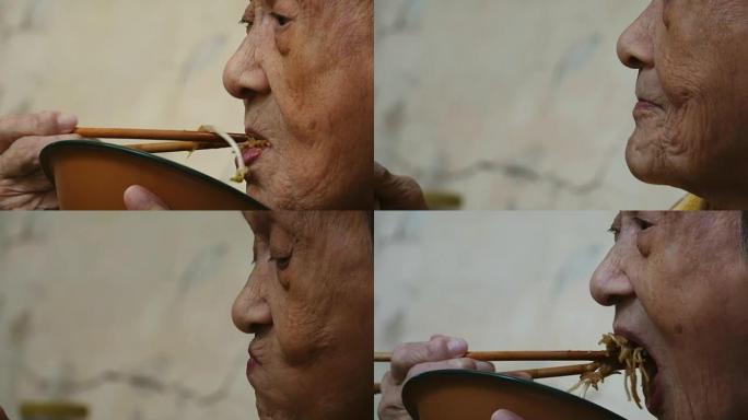 90岁以上健康的亚洲老妇吃午饭，侧视。