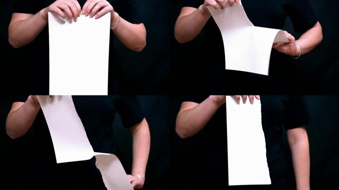 用一张纸双手合十。撕下一张白纸。