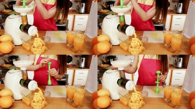 在榨汁机4K中制作橙汁的女人
