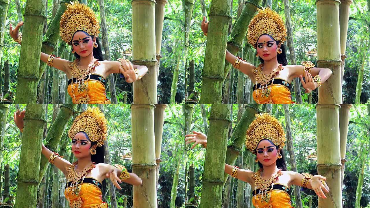 年轻的巴厘岛舞者在竹林中表演Legong舞蹈