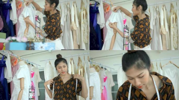 亚洲女性，制衣工人正在测量面料店缝制的衬衫的长度。