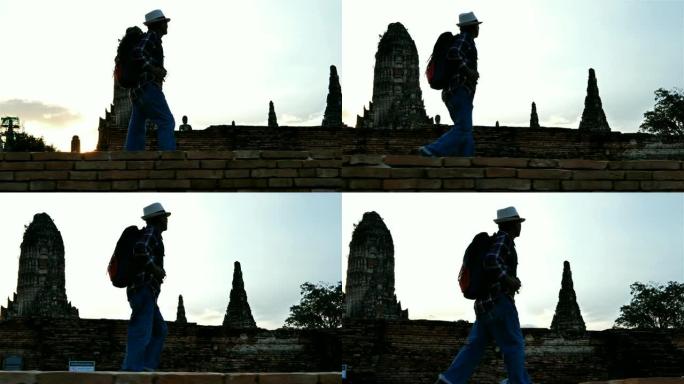 带背包的亚洲老人正在Chaiwatthanaram Wat散步。古代和历史景点以及泰国大城府最重要的