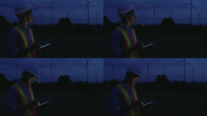 工程师在夜间进行风力涡轮机评估