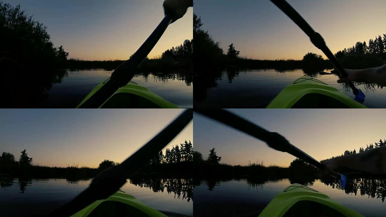 双手划着皮划艇视点，平静的水反射日落