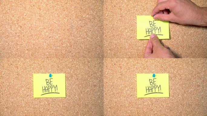 在一个男人钉在软木板上的纸上快乐单词组