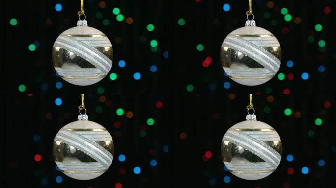 圣诞装饰品，球挂在闪烁的灯光背景上。
