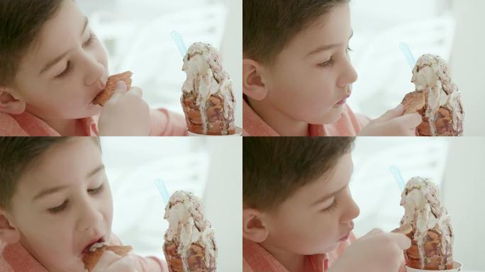 男孩在桌子上挖软冰淇淋的特写镜头