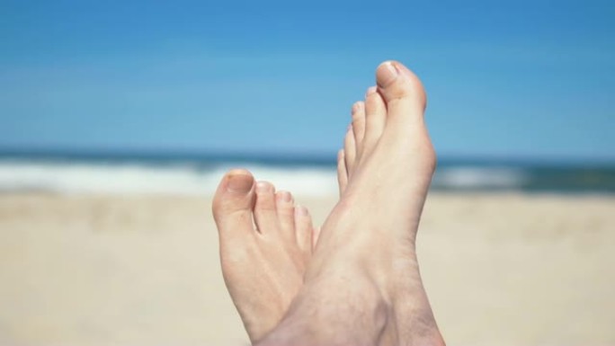 4k分辨率慢动作60fps躺在沙滩上的男人的脚