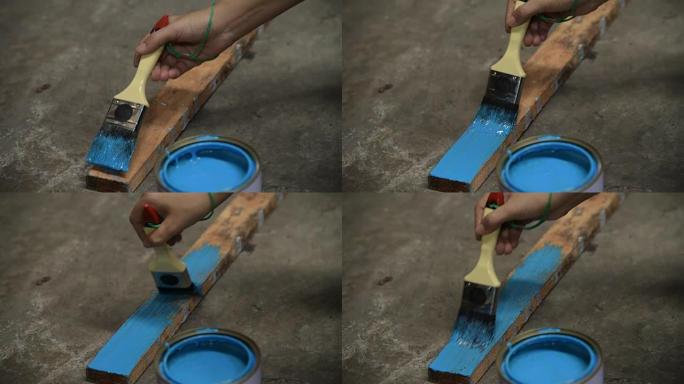 人的手在木棍上画蓝色