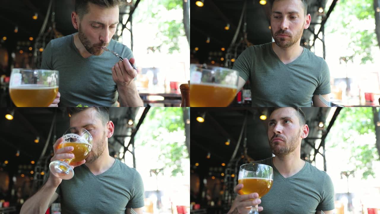 男子在餐厅吃食物和喝啤酒