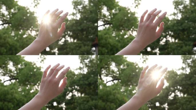 女性单手伸手触摸阳光