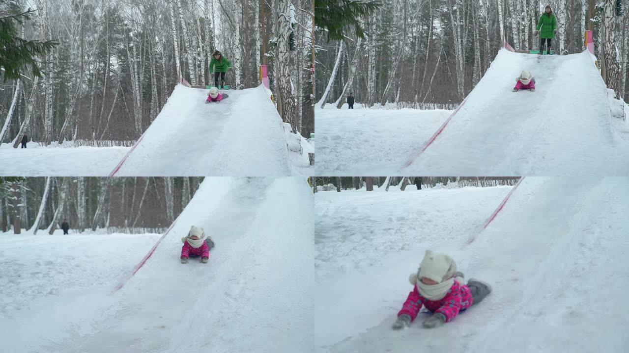 小女孩从大冰滑梯头朝下骑行