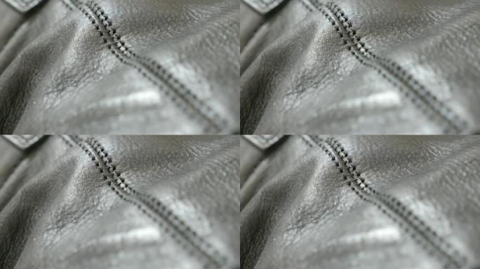 两个闪亮皮革层的接缝连接细节特写4K 2160p 30fps超高清倾斜镜头-人造天然皮革织物的纹理4