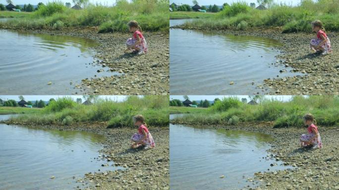 小女孩把石头扔进水里