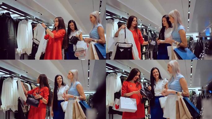 女孩在商店里选择衣服和女人的手提包，并与她的朋友咨询