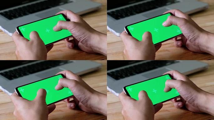 双手使用智能手机触摸屏色度关键人物在智能手机上玩游戏