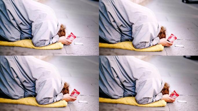 2017年9月7日，意大利威尼斯: 乞丐在意大利威尼斯的街道上要求施舍。悲伤的无家可归的女人站在街上