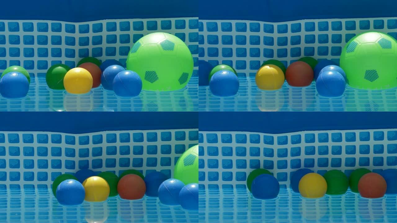 不同颜色的球漂浮在一个小型夏季游泳池的水中