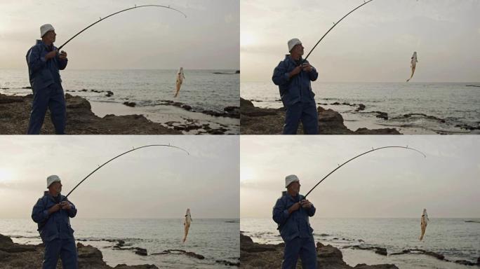 老渔夫在沙滩上钓到一条大鱼
