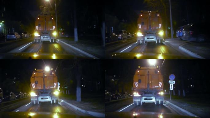 汽车吸尘器往前走，晚上在镜头前打扫街道。
