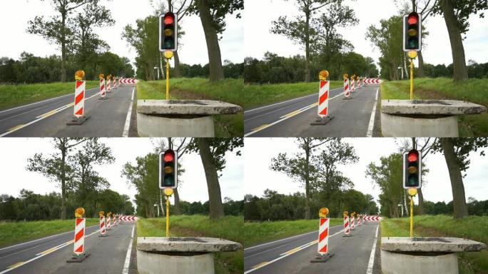 道路工程，开挖时标有障碍物和橙色闪烁的警示灯。因整修而阻塞街道交通。