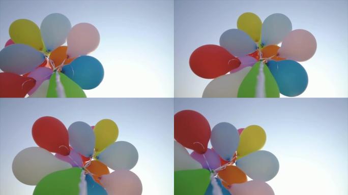 夏天，一堆彩色气球对着蓝天