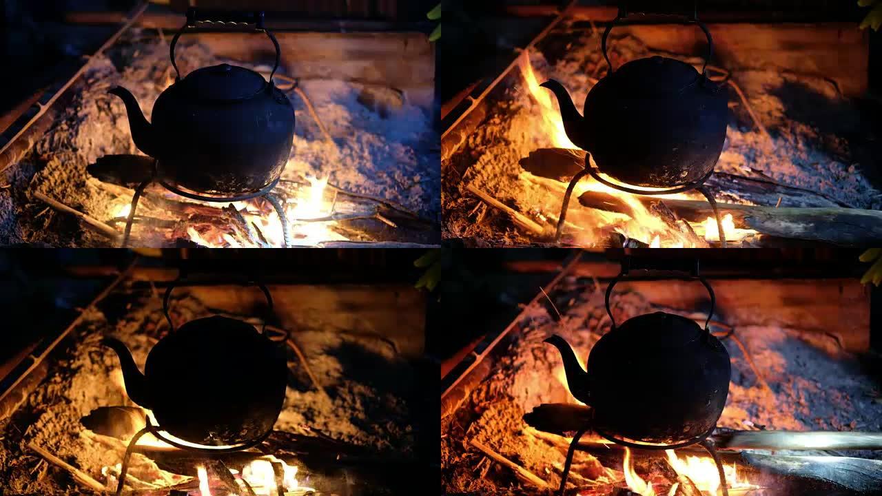 关闭开水锅，将柴火推入森林露营时开火。