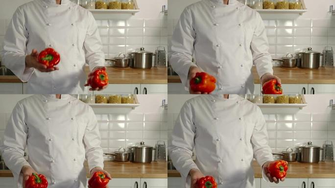 首席炊具在厨房里摆弄红辣椒的铃铛-慢动作