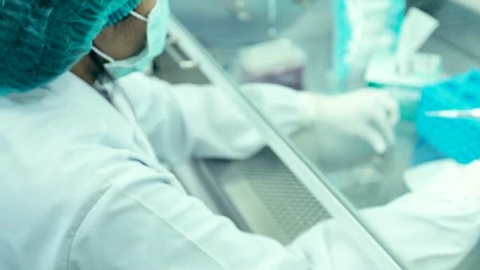 科学家们正在细胞培养室中改变培养基来培养细胞，概念科学与技术