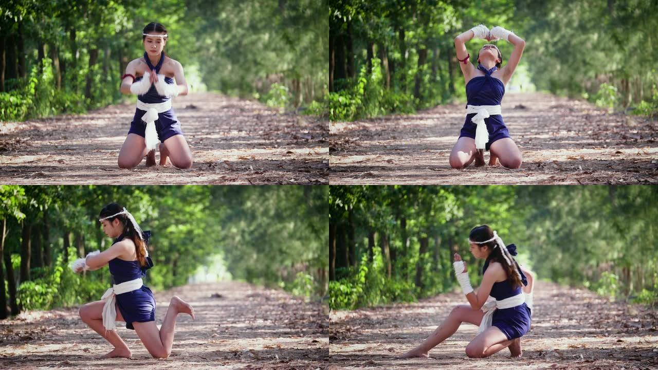 年轻的亚洲拳击手女子或泰拳在户外战斗前祈祷仪式，泰国拳击和武术概念