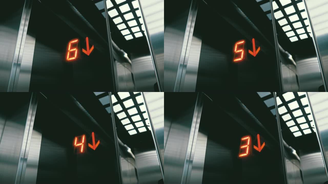 电梯中的数字显示，从地板下降，箭头向下