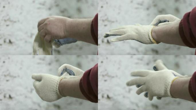 男子戴上棉布点状工作手套准备工作