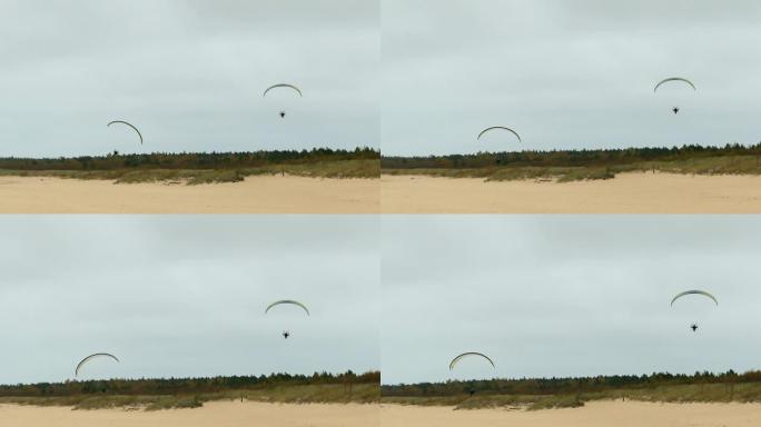 动力滑翔伞在沙滩上飞得极低