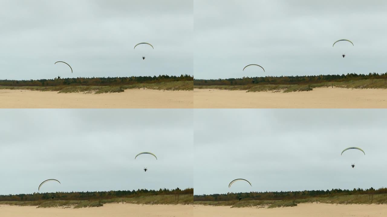 动力滑翔伞在沙滩上飞得极低