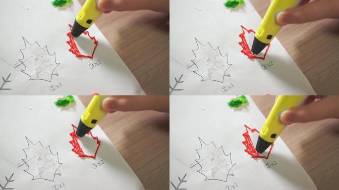 特写男孩的手使用3D笔。他用红色ABS塑料创造了一片植物叶子。