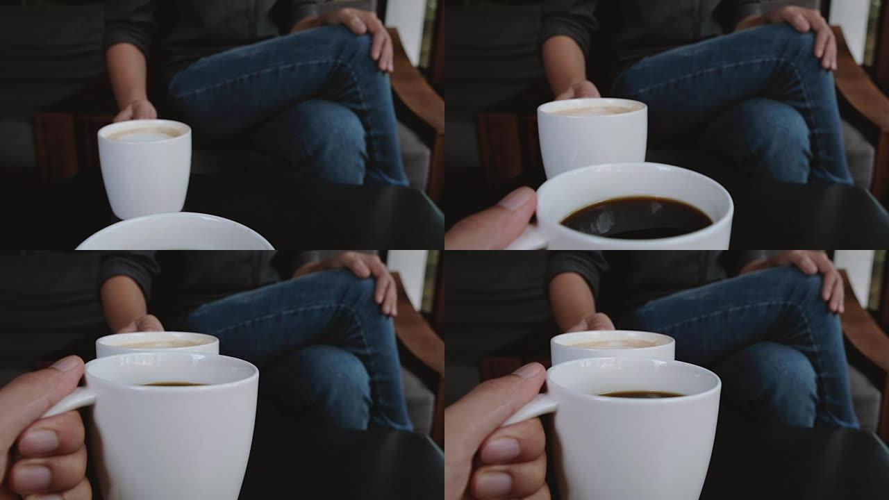 两个人在咖啡馆里碰碰白色咖啡杯的特写照片