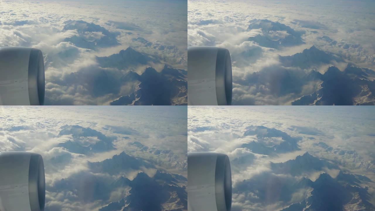 从喷气式飞机上观察瑞士阿尔卑斯山。其中一个大引擎清晰可见