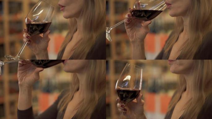 喝红酒的美女特写。一位享受酒杯的迷人女士的肖像。