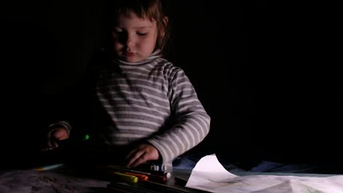 小女孩在桌子上选择彩色记号笔和铅笔，学会在纸上画画-家庭教育