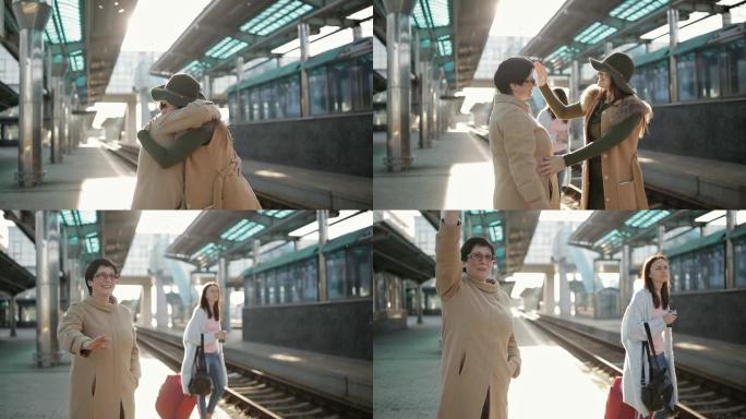 成年妇女护送他的女儿在火车站的月台上。