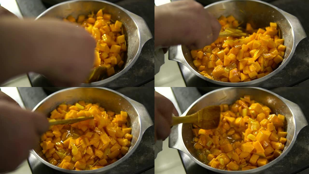 厨师准备了一个南瓜菜，用勺子将这些碎片混合在盘子里