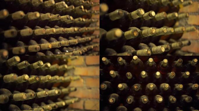 酒窖里满是灰尘的旧酒瓶。葡萄酒的生产。深色酒窖配可收藏的红酒。4K (UHD