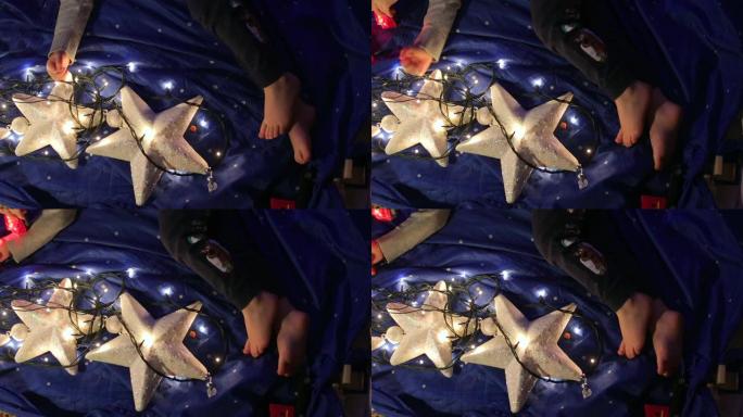 婴儿脚躺在蓝色背景上，白色星星