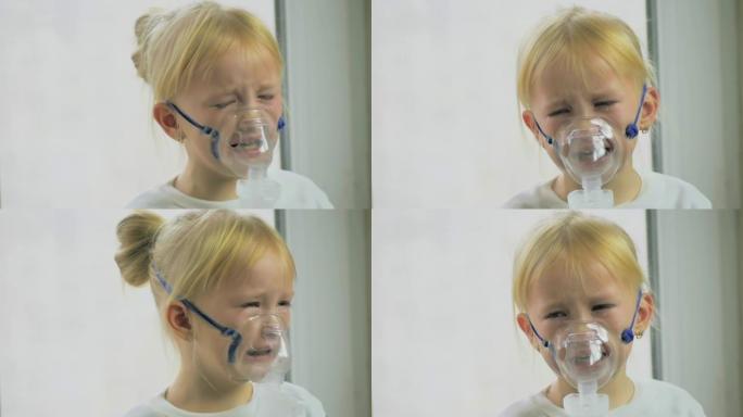 四岁的女孩戴着口罩通过医院的吸入器慢动作呼吸气体。