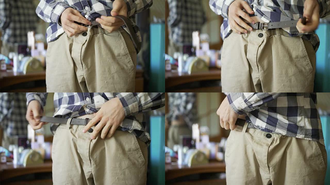男人的手穿上休闲裤或短裤和紧身带特写