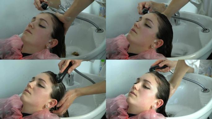 美容沙龙。理发店。女孩在理发店洗头。女孩放松了。